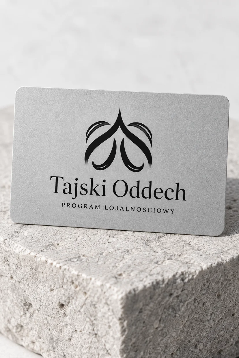 Jasnoszara karta Tajski Oddech z czarnym logo na naturalnym kamieniu